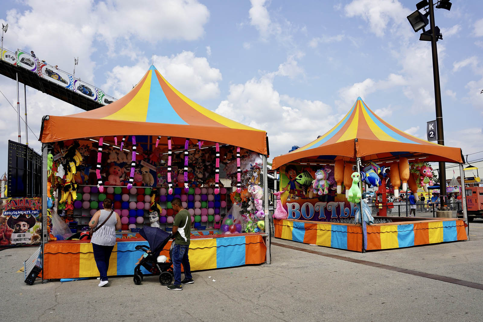 Player tossing ring onto bottles at carnival game