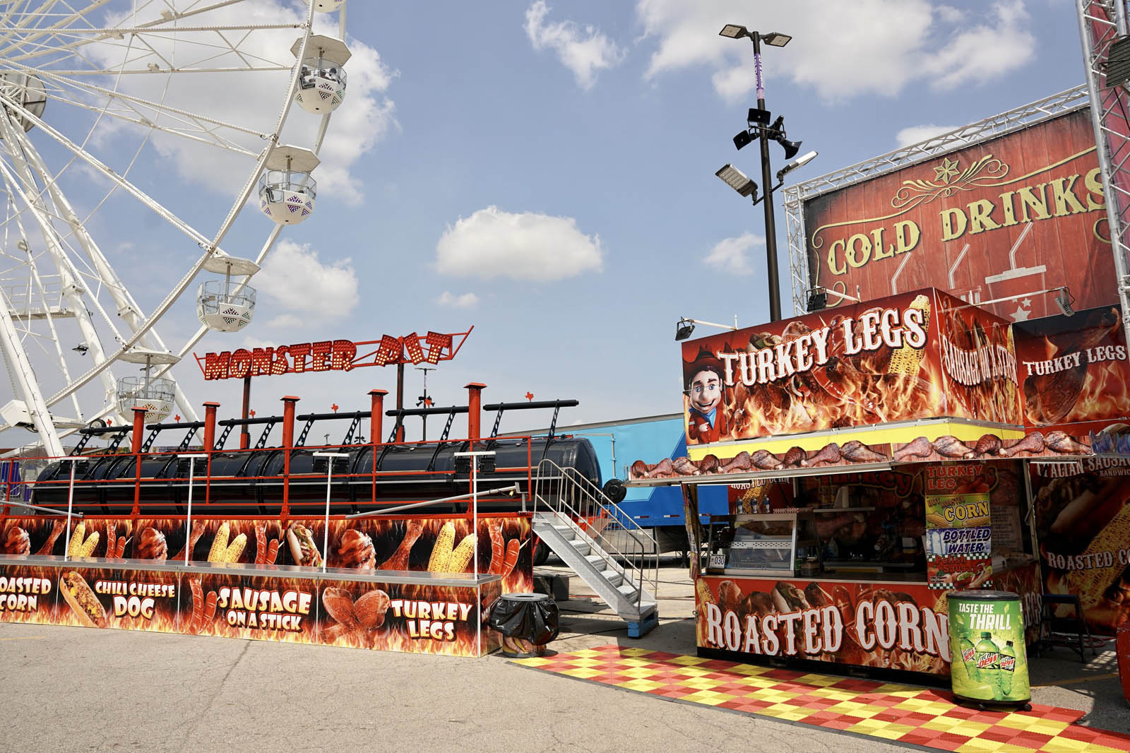 Tom’s Smokehouse & Monster Pit concession stand with giant smoker