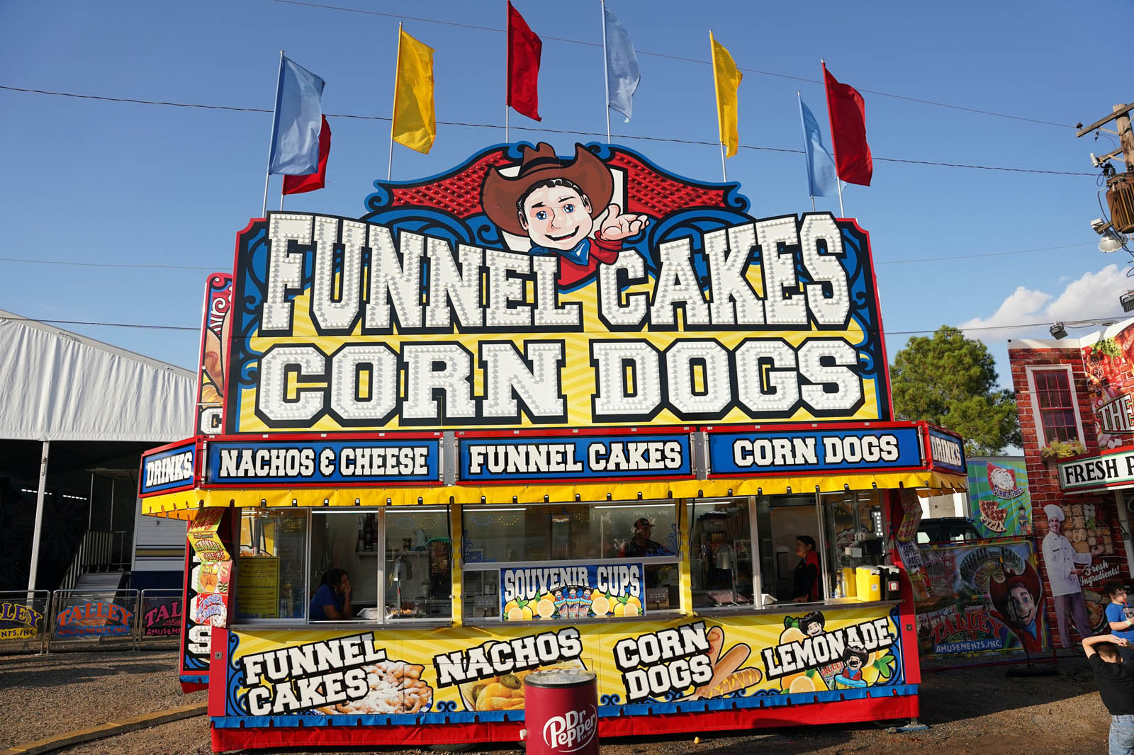 Jumbo corn dogs and funnel cakes at carnival food stand